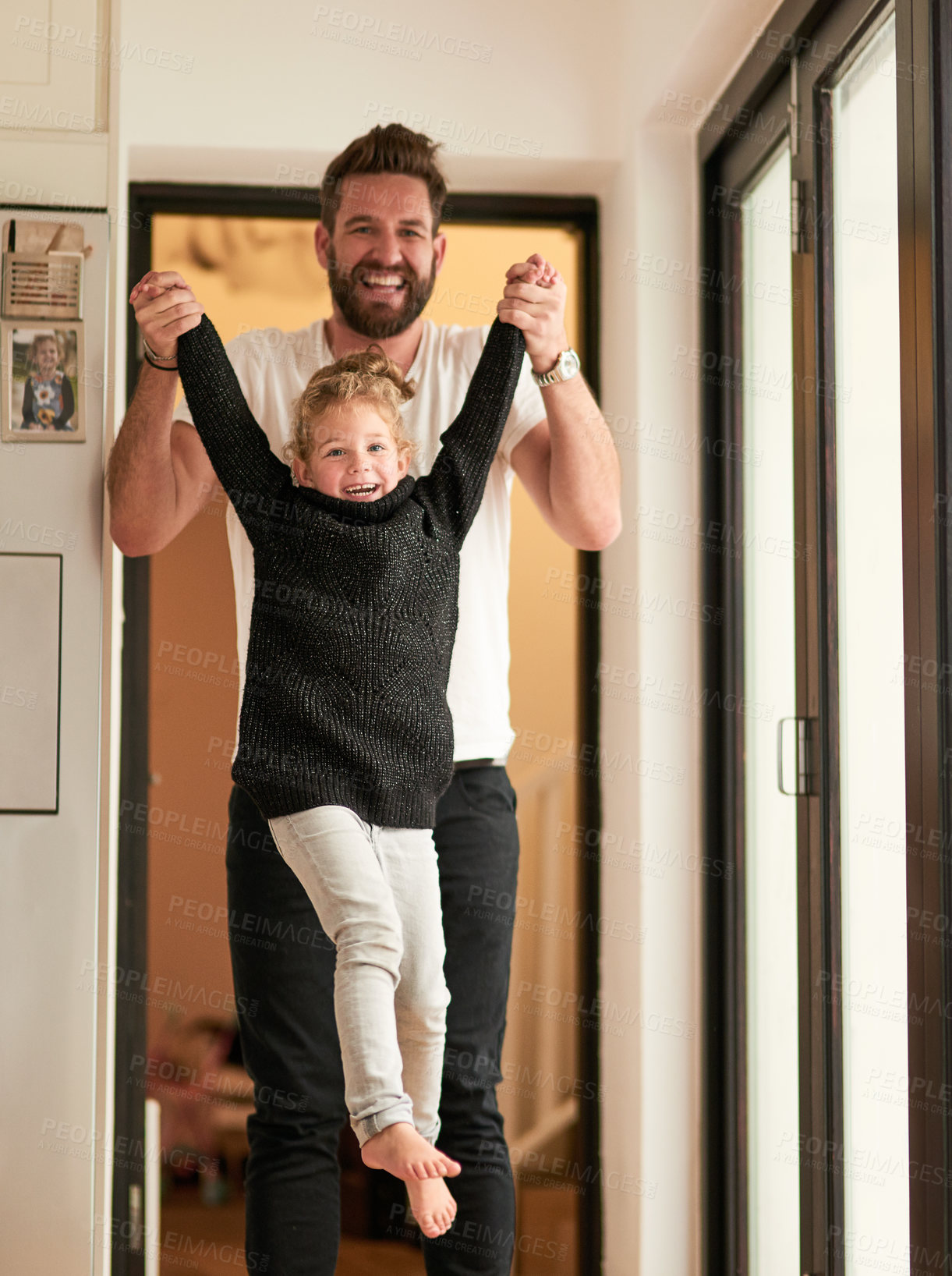 Buy stock photo Home, lift and girl with hands of father for trust, support and bonding together on fathers day. Kid, man and portrait with smile at apartment for playful fun, love and safety in child development