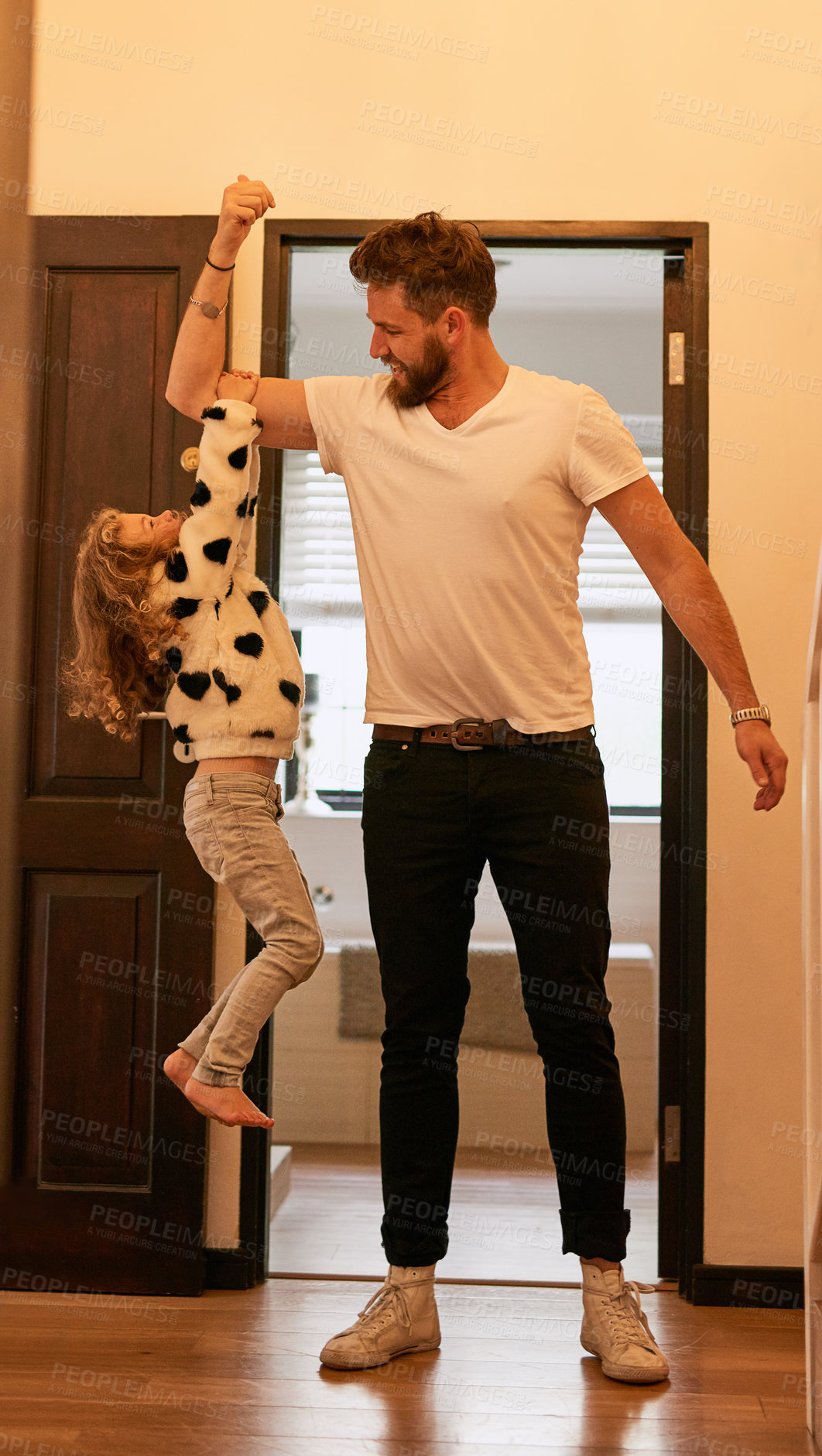 Buy stock photo Home, lifting and girl with arm of dad for strength, support and bonding together on fathers day. Kid, man and playful with smile at apartment for love, trust and family fun in child development