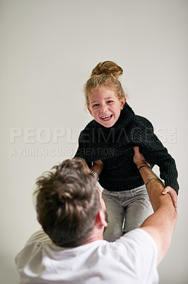 Buy stock photo Cropped shot of a father and daughter bonding together at home