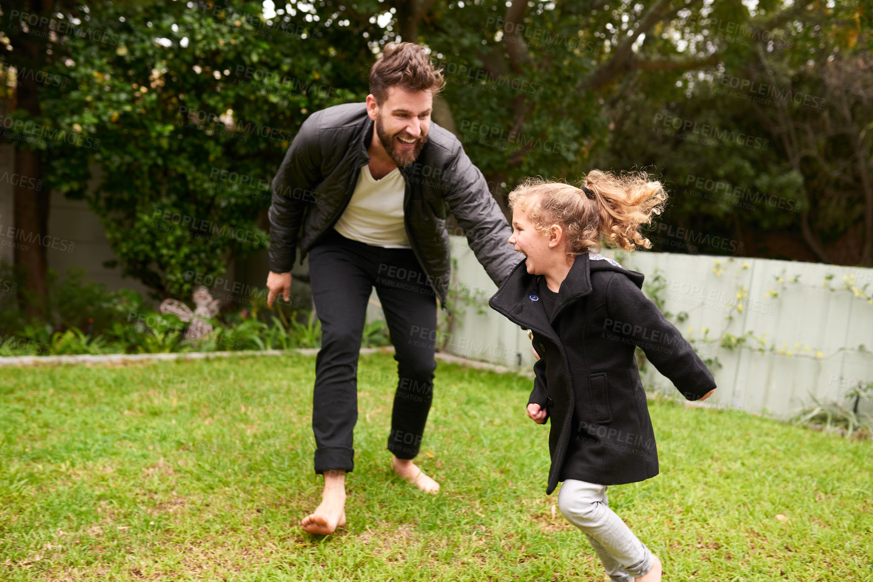 Buy stock photo Shot of a father and daughter playing together outside