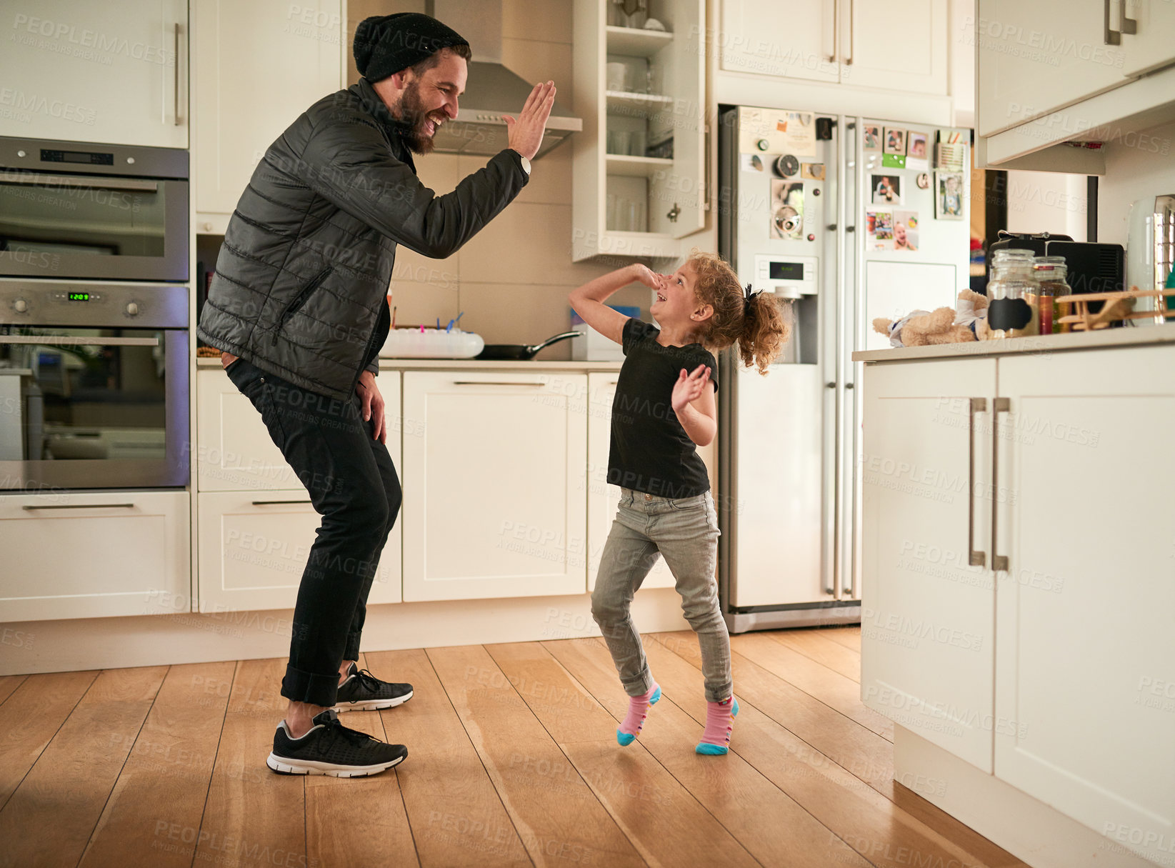 Buy stock photo Shot of a little girl giving her father a high five