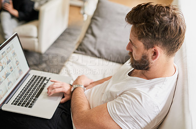 Buy stock photo Shot of a man relaxing with wireless technology at home