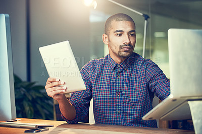 Buy stock photo Laptop, serious and business man reading email, research or information on tablet at night in startup. Computer, tech and professional in office on app, deadline or creative web designer on project