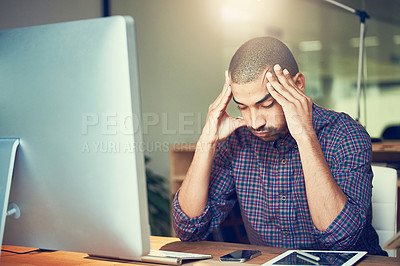 Buy stock photo Cropped shot of a stressed out designer working late in an office