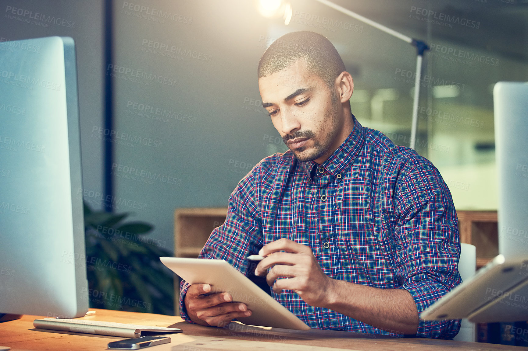 Buy stock photo Cropped shot of a young designer working late in an office