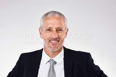 Buy stock photo Studio portrait of a smiling mature businessman against a gray background