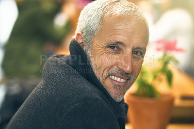 Buy stock photo Portrait of a mature man sitting inside a cafe