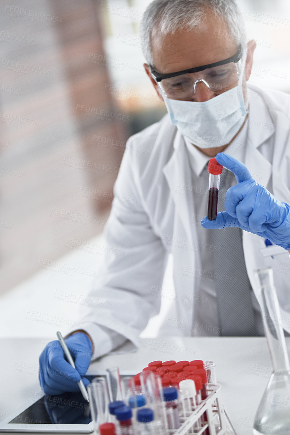 Buy stock photo Cropped shot of a mature doctor in his lab