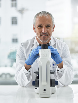Buy stock photo Portrait of a researcher at work on a microscope in a lab