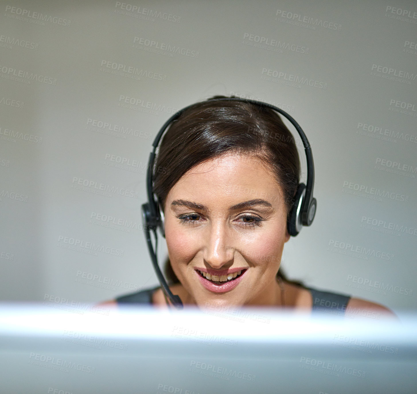 Buy stock photo Shot of a professional woman using a computer and headset at her desk