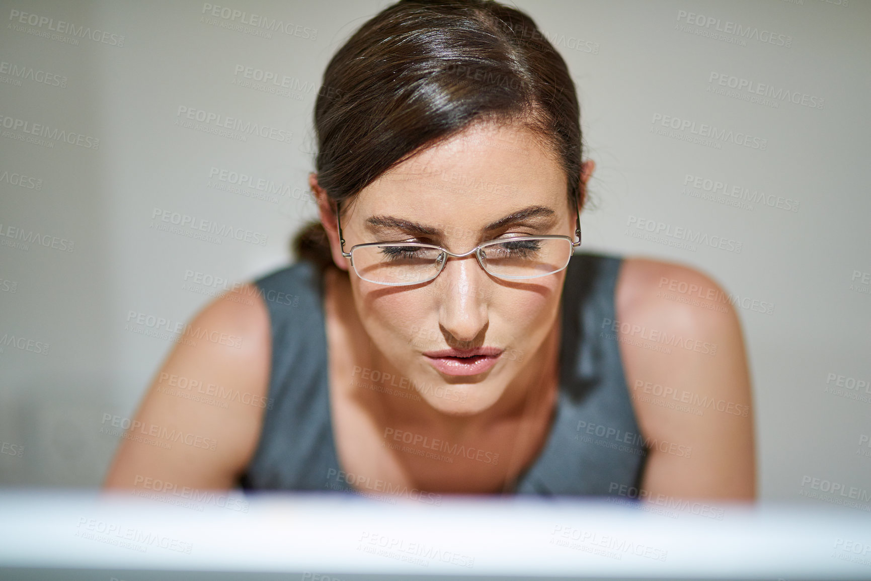 Buy stock photo Shot of a professional businesswoman using a computer at her office desk