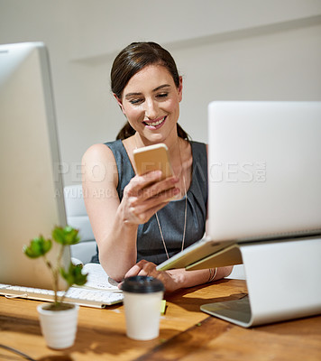 Buy stock photo Shot of a professional businesswoman using a phone at her office desk