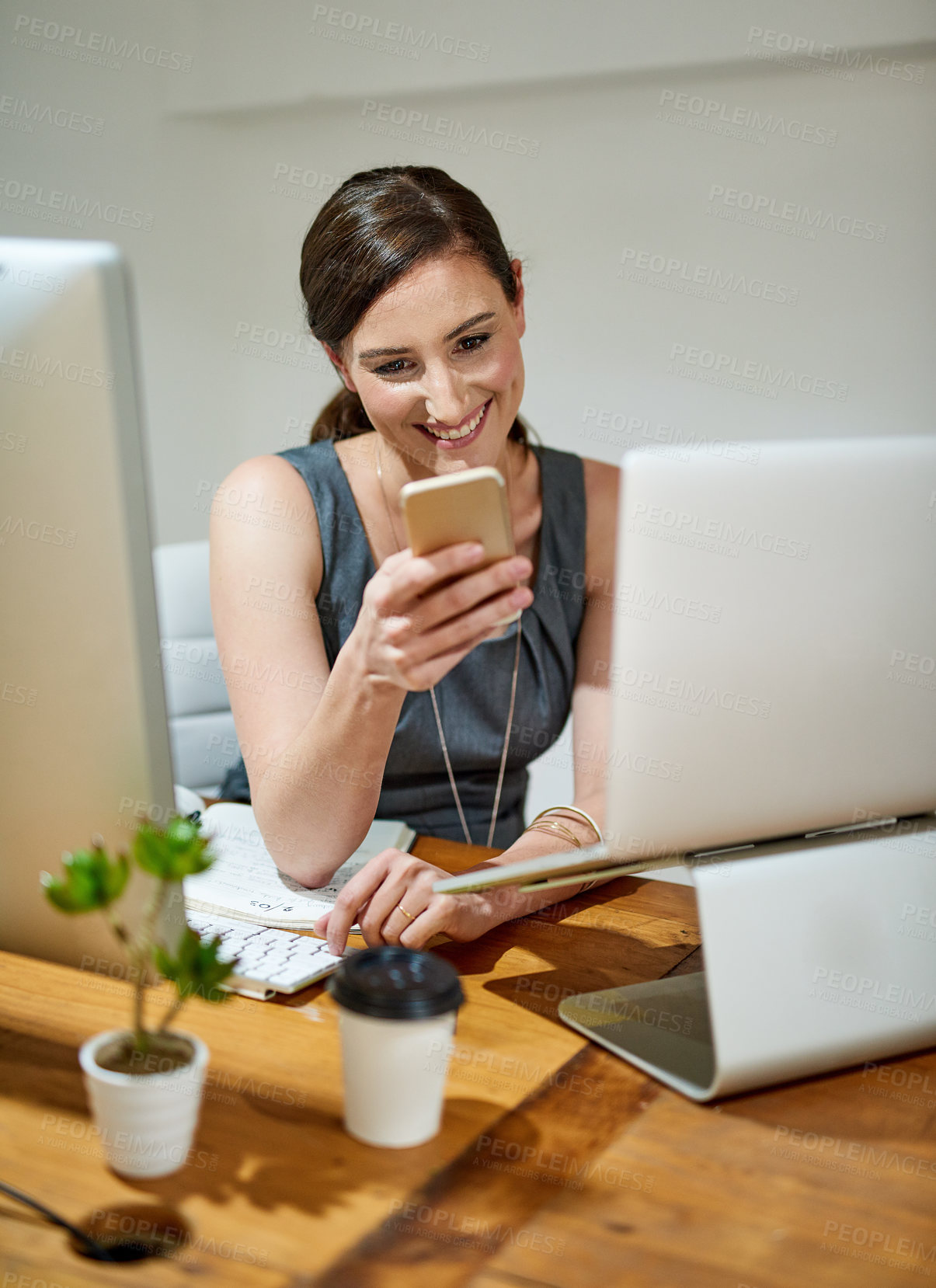 Buy stock photo Shot of a professional businesswoman using a phone at her office desk
