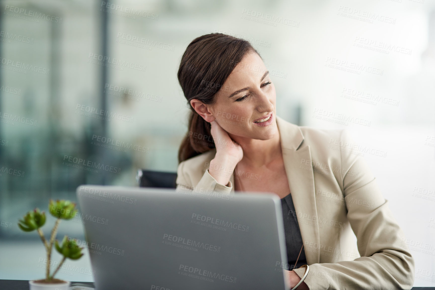 Buy stock photo Shot of a businesswoman suffering from neck pain at her office desk