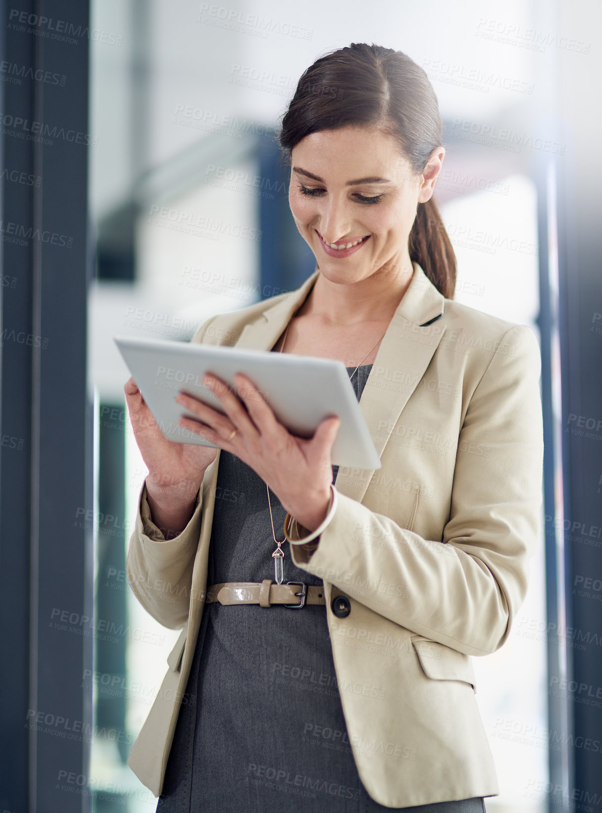Buy stock photo Shot of a professional businesswoman using a digital tablet at work