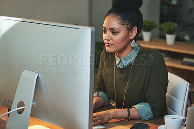 Buy stock photo Shot of an attractive young woman working on her computer in the office