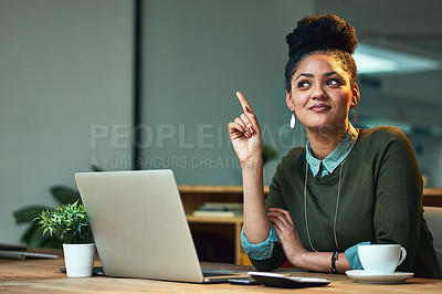 Buy stock photo Shot of an attractive young woman having a lughtbulb moment while working on her laptop in the office