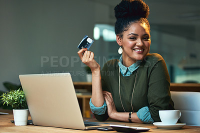 Buy stock photo Portrait of an attractive young woman shopping online while working in the office
