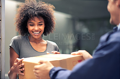 Buy stock photo Shot of a courier making a delivery to a smiling customer