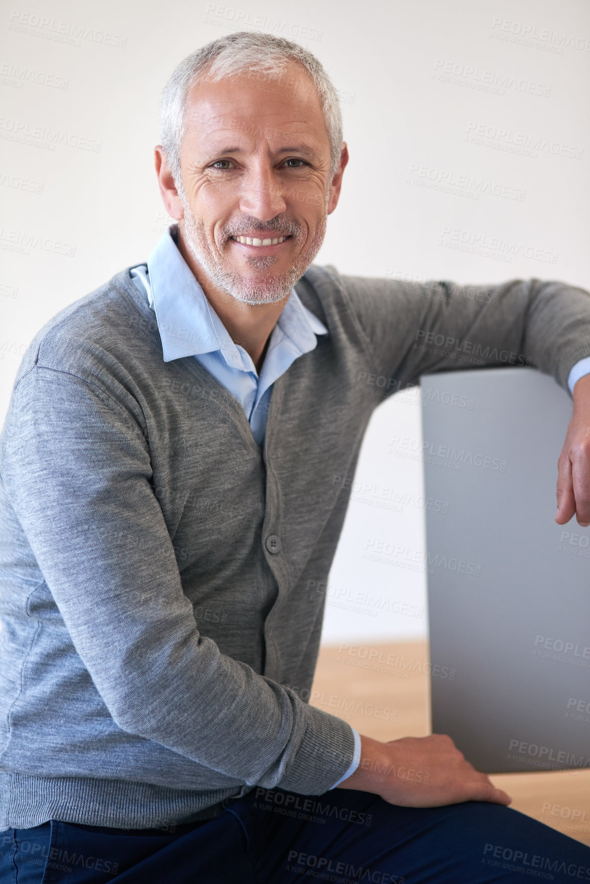 Buy stock photo Portrait of a mature businessman leaning on his computer in the office