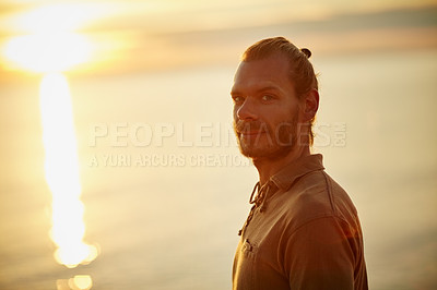 Buy stock photo Portrait of a man relaxing at the beach during sunset