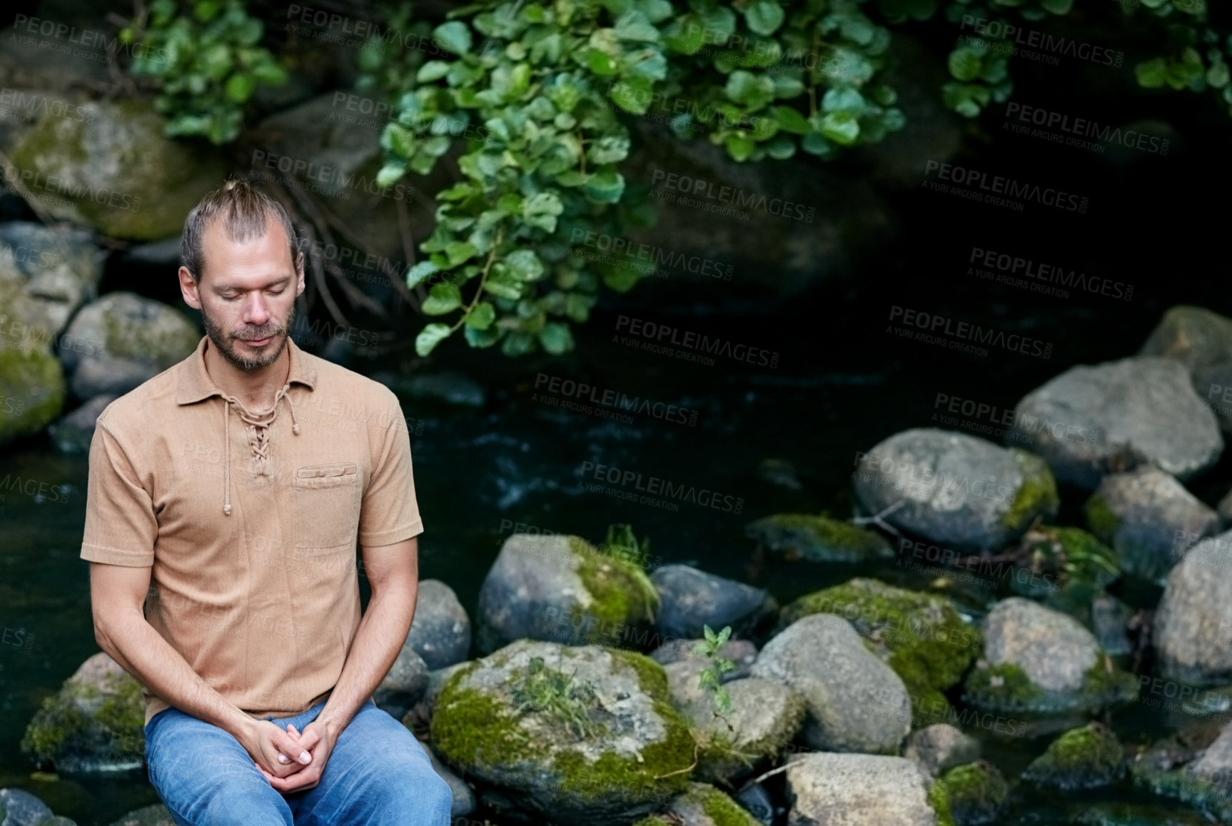 Buy stock photo Shot of a handsome man meditating outdoors