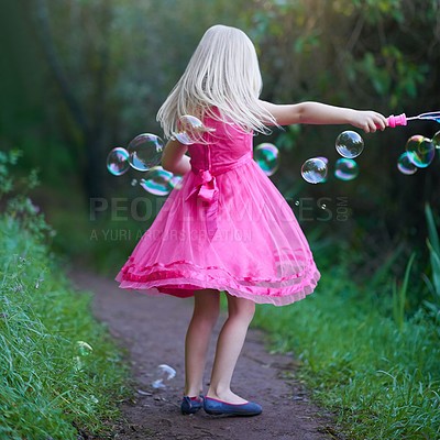 Buy stock photo Garden, playing and girl child with bubbles, adventure and outdoor holiday fun in nature from back. Growth, development playful kid in backyard with grass, soap and princess energy on summer weekend