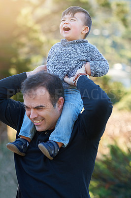 Buy stock photo Cropped shot of a father bonding with his little boy outside
