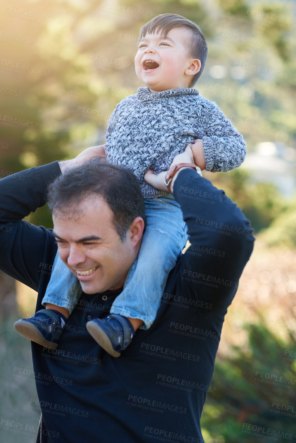 Buy stock photo Cropped shot of a father bonding with his little boy outside