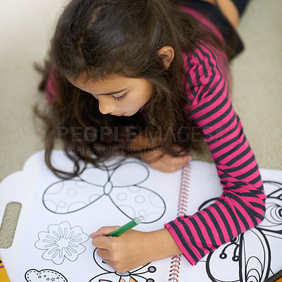 Buy stock photo Shot of a cute little girl colouring in on her own at home