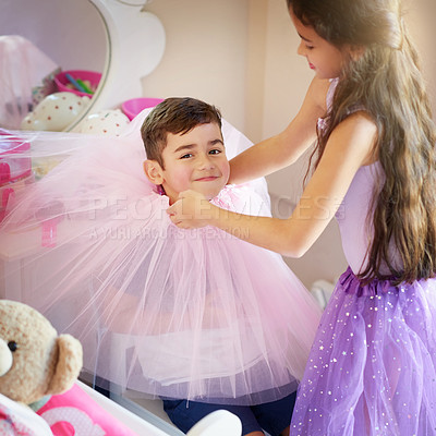 Buy stock photo Shot of a cute little girl playing dress up with her brother at home