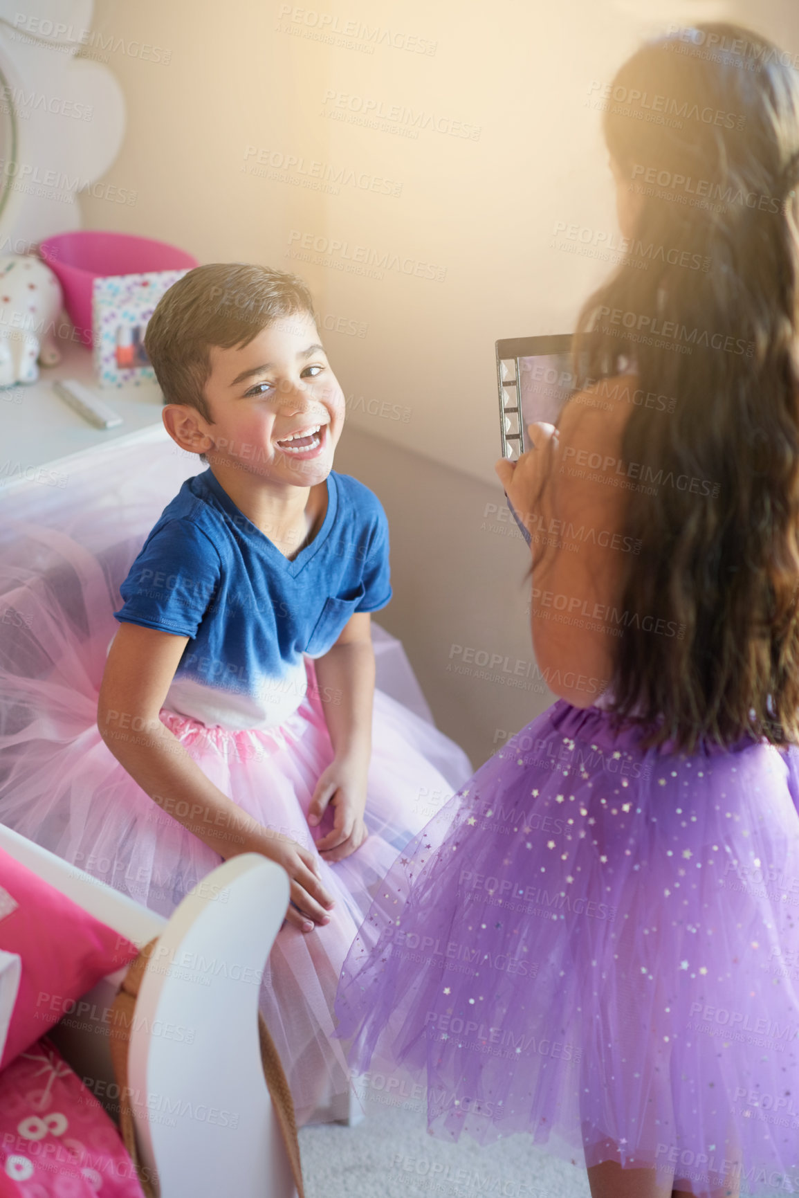 Buy stock photo Shot of a cute little girl playing makeover with her brother at home