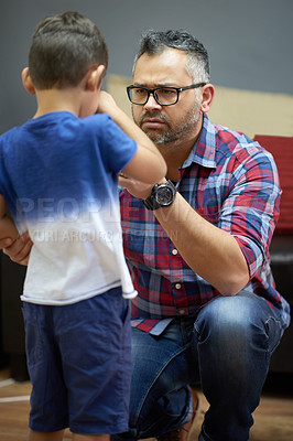 Buy stock photo Shot of a concerned father consoling his little boy at hoome