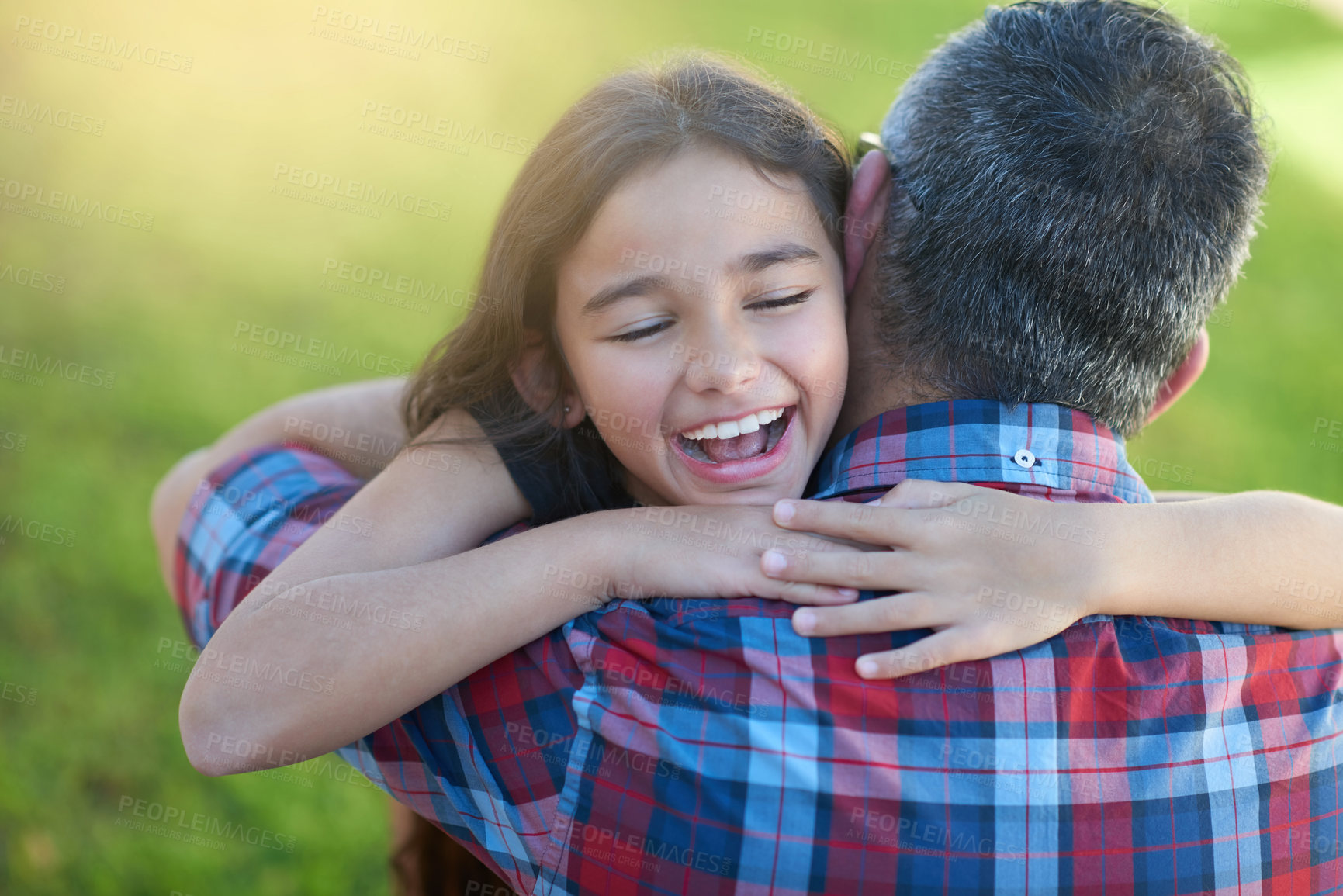 Buy stock photo Shot of a happy little girl hugging her father at home