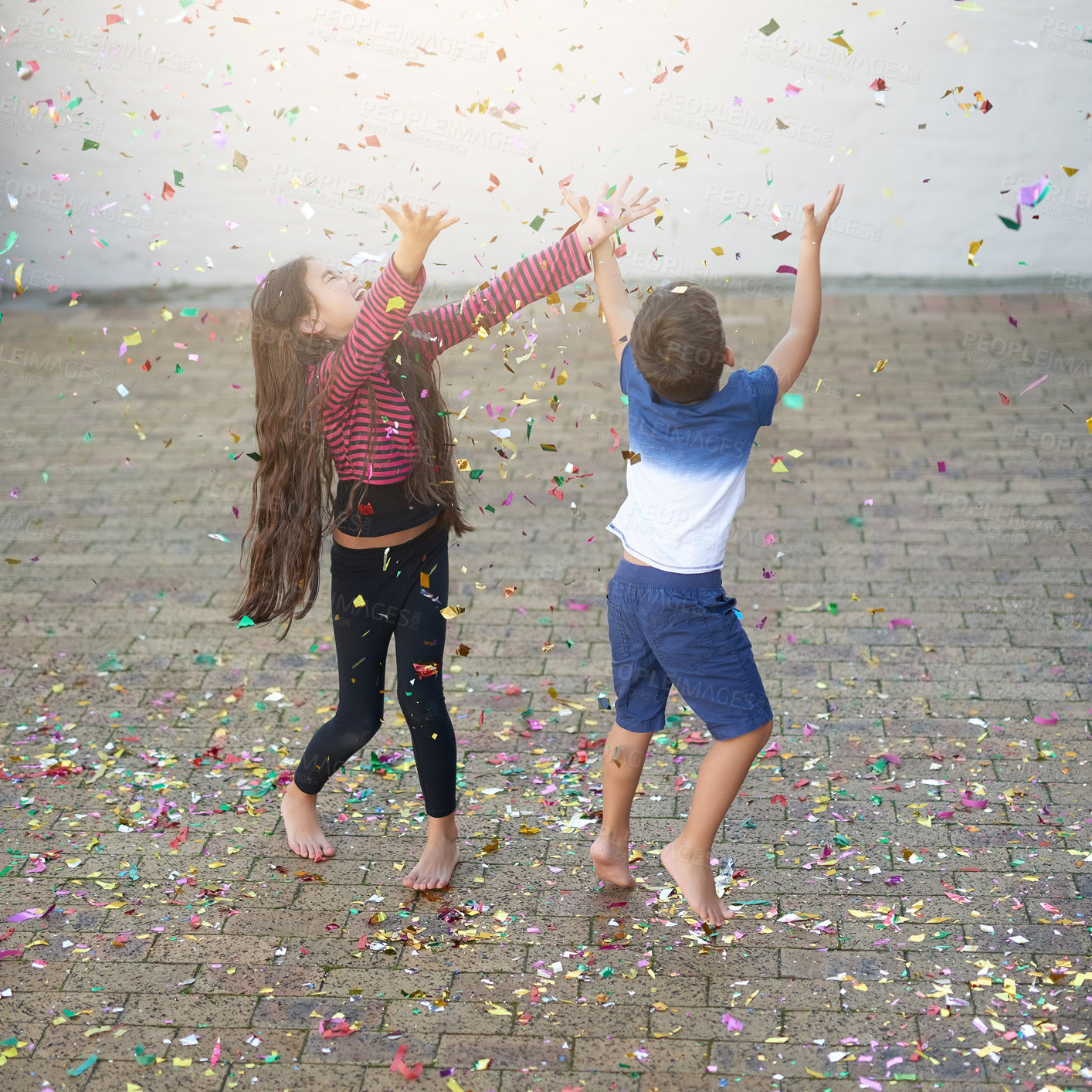 Buy stock photo Confetti, playing and fun for kids, outdoor and happiness in home, summer and weekend for siblings. Celebration, boy and girl jumping in birthday, excited and children in house with joy for party