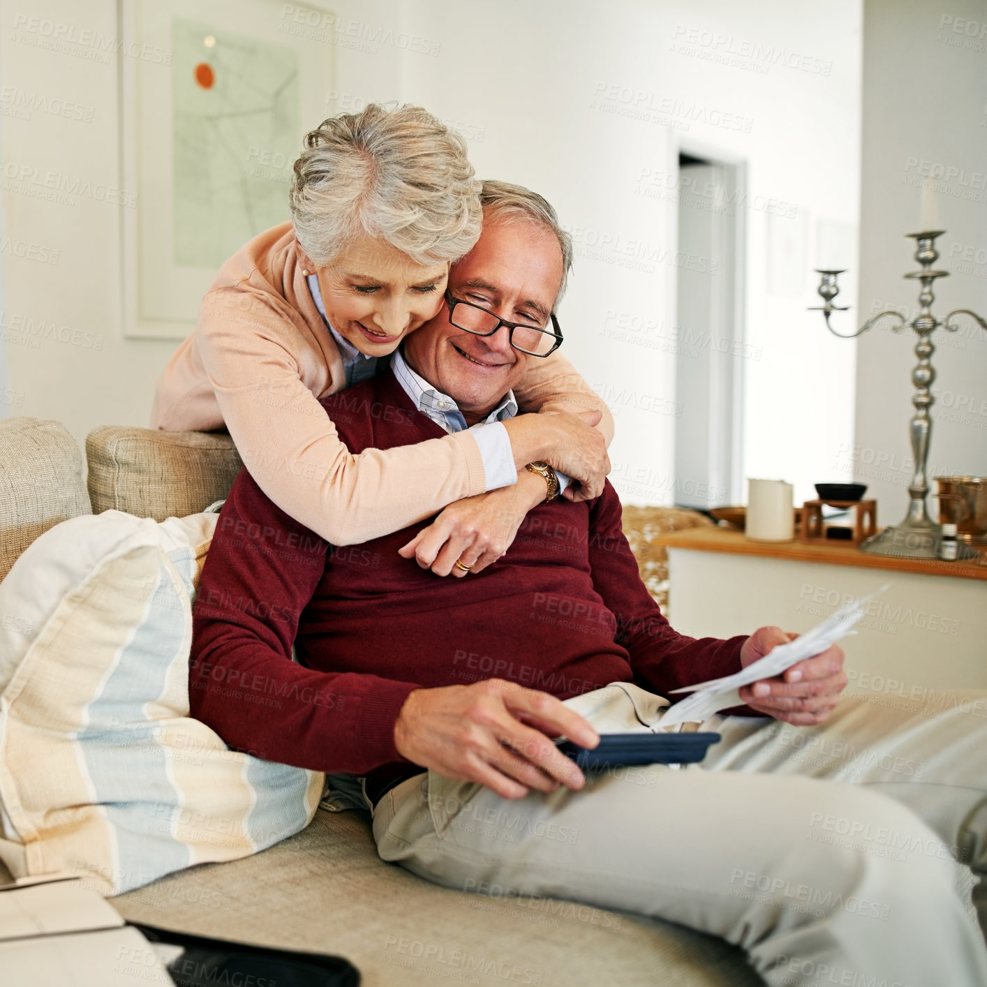 Buy stock photo Senior couple, couch and hug in home with love, marriage and romance for husband and woman in lounge. Sofa, relax and embrace for man with paper instructions, retirement and trust for happy people