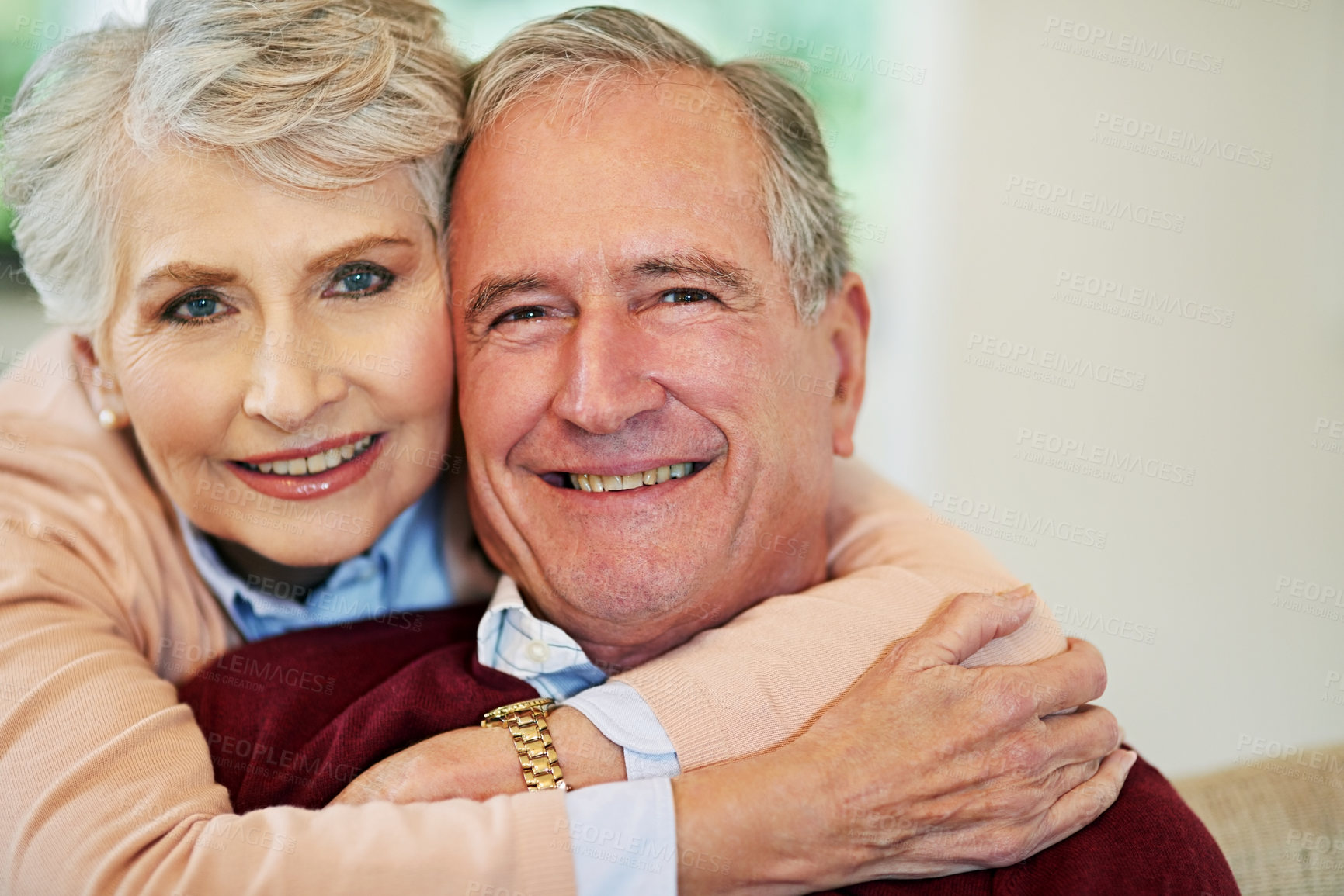 Buy stock photo Shot of a senior woman embracing her husband from behind