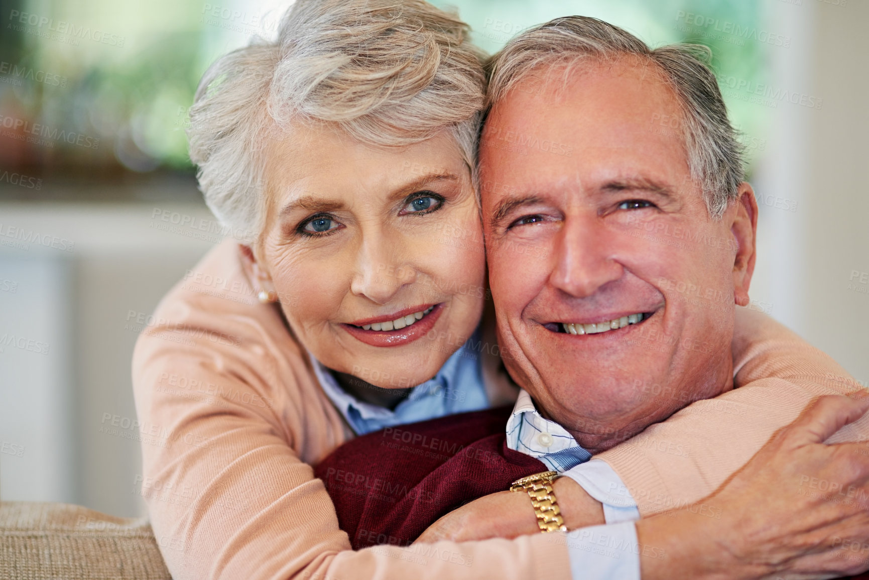 Buy stock photo Shot of a senior woman embracing her husband from behind
