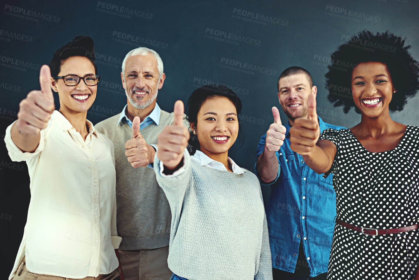 Buy stock photo Portrait, thumbs up and happy team of business people with thank you, success or about us at creative startup. Staff, group or like hand sign for diverse designer isolated on a dark studio background