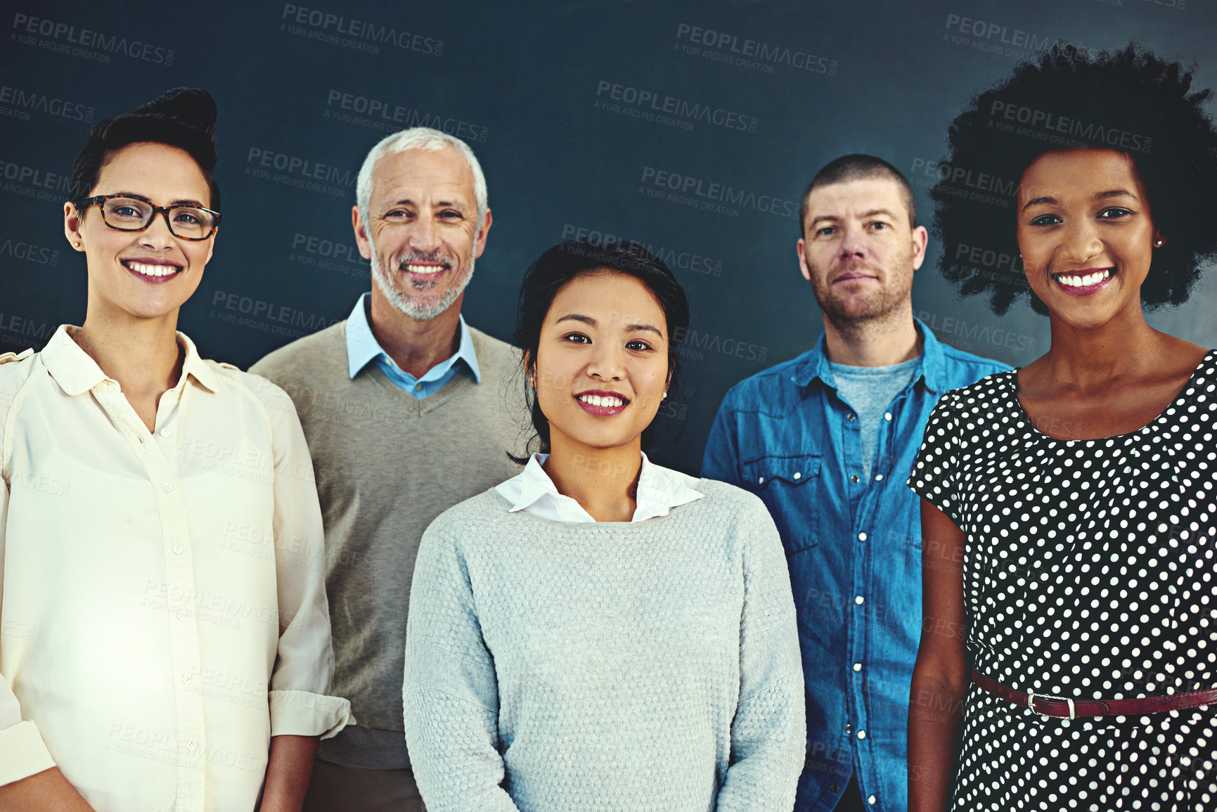 Buy stock photo Portrait of a diverse team of creative colleagues posing in the studio