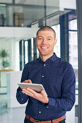 Buy stock photo Portrait of a businessman using a digital tablet in a modern office