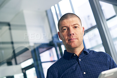 Buy stock photo Portrait of a businessman using a digital tablet in a modern office