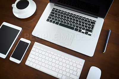 Buy stock photo High angle shot of various digital devices on a table