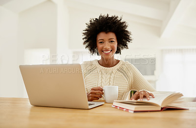 Buy stock photo Portrait of an attractive young using her laptop, reading a book and drinking some coffee at home