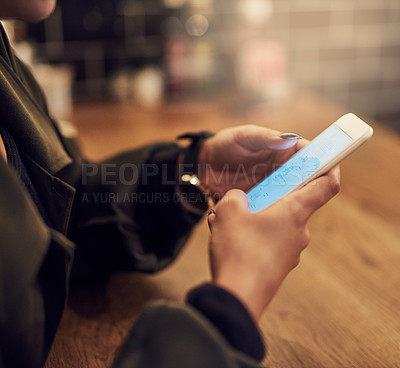 Buy stock photo Cropped shot of a woman using her cellphone in a cafe