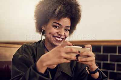 Buy stock photo Portrait of a beautiful young woman using her cellphone in a cafe