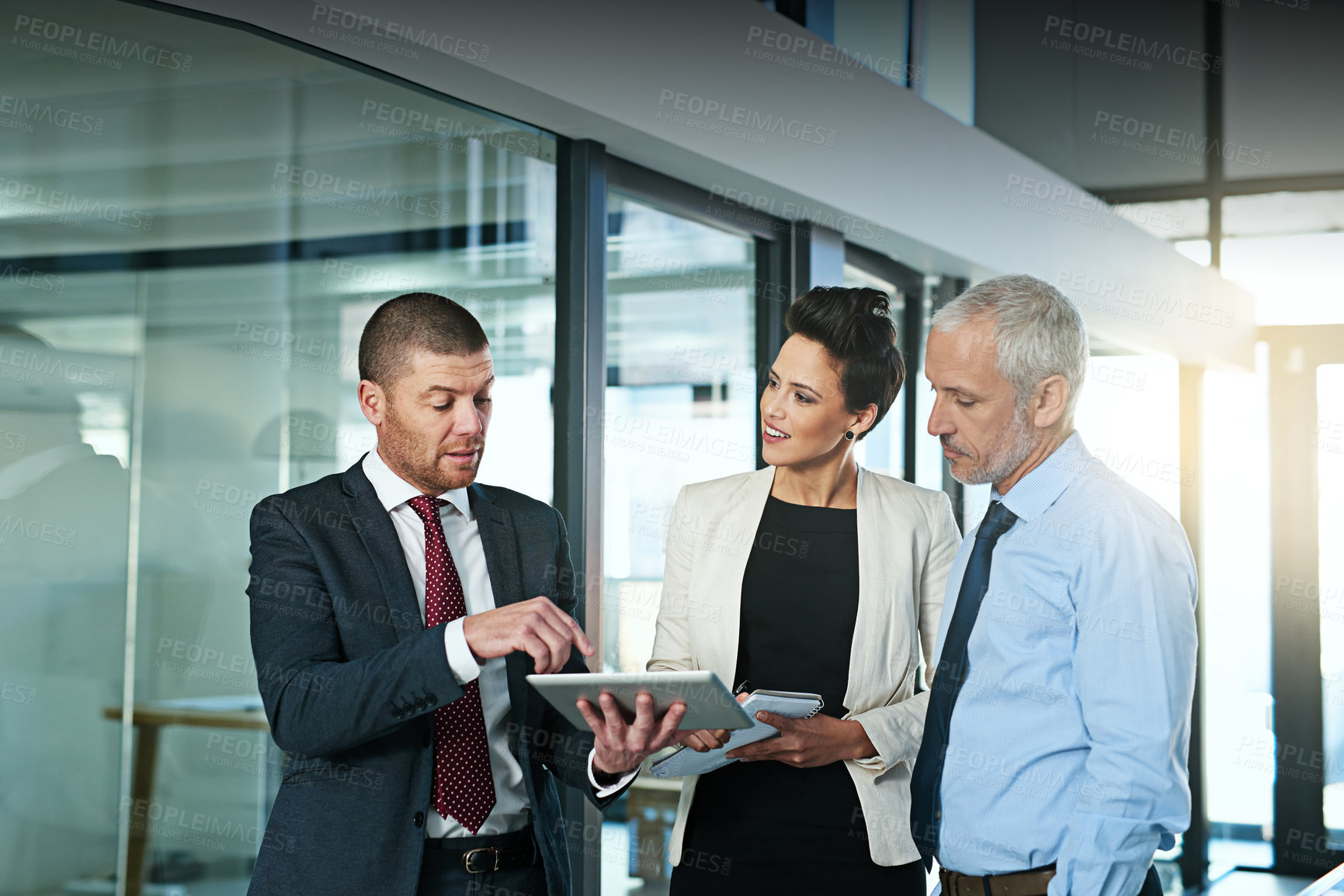 Buy stock photo Business team, tablet and discussion in office, standing and ideas for planning, project and colleagues. Group, technology and collaboration for analyse, meeting and corporate workers for teamwork