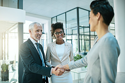 Buy stock photo Shot of businesspeople shaking hands in an modern office