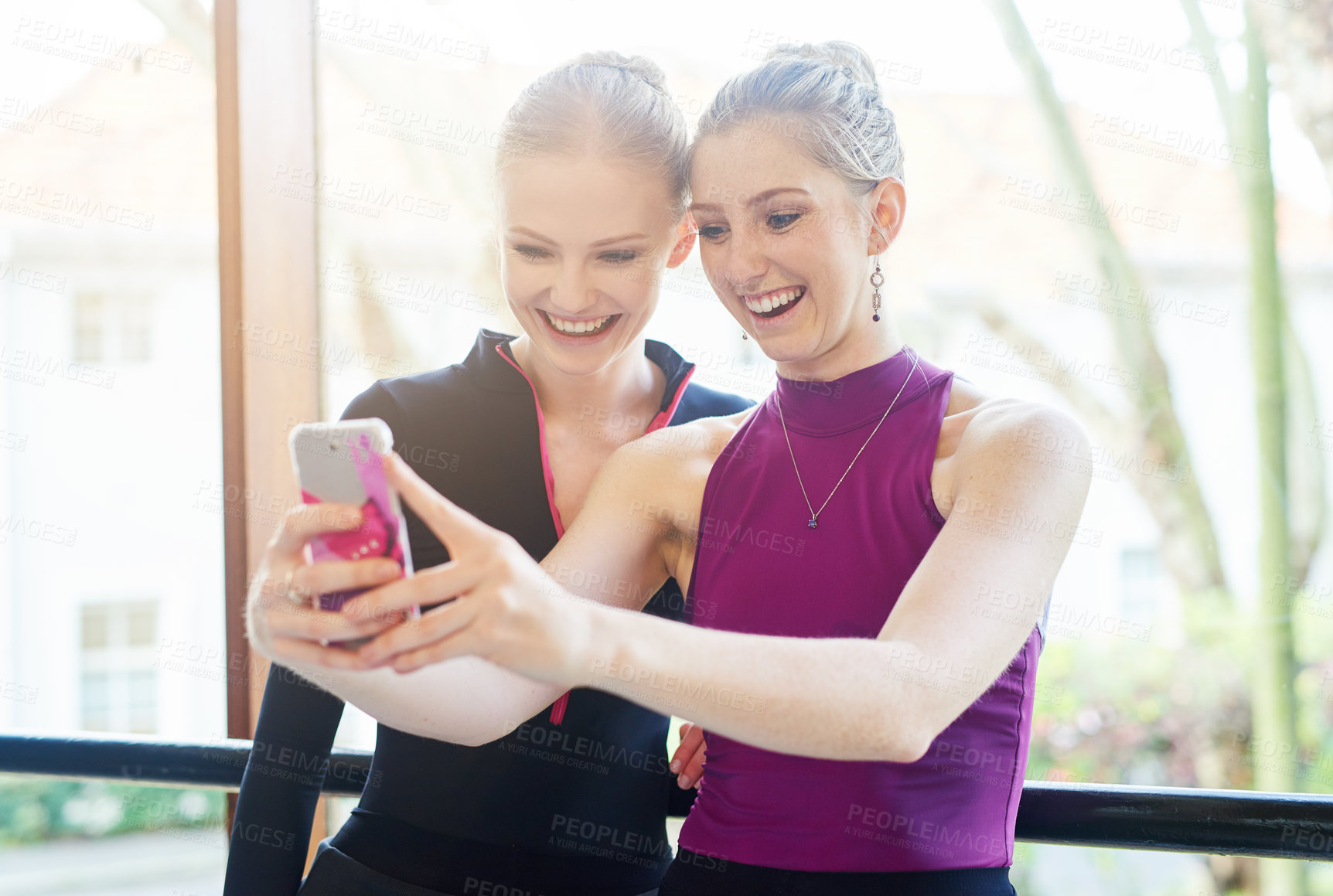 Buy stock photo Cropped shot of two sporty young women taking a selfie after their workout