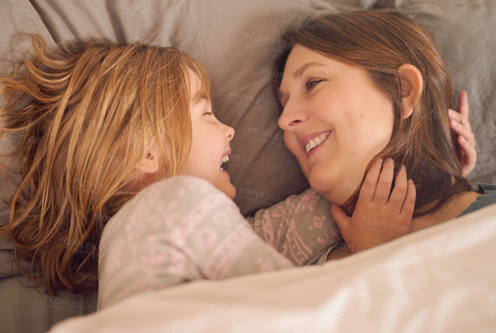 Buy stock photo Mother, child and laughing on bed with love for relax, bonding together and fun weekend in family home. Mom, happy and young girl on mattress in house with smile, morning joke and funny in bedroom